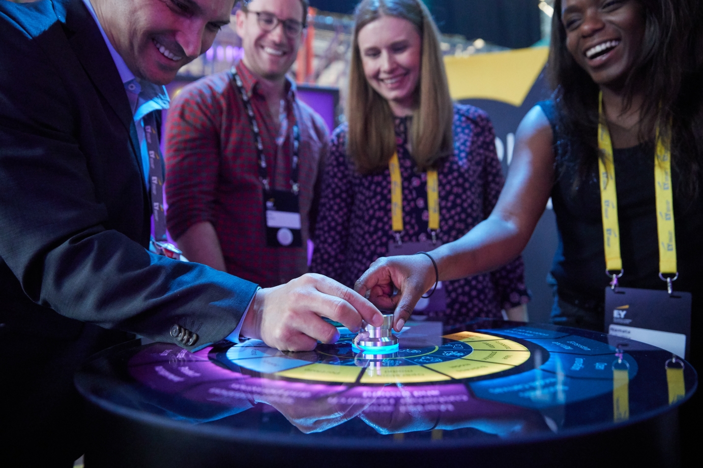 Many people holding a dial together
